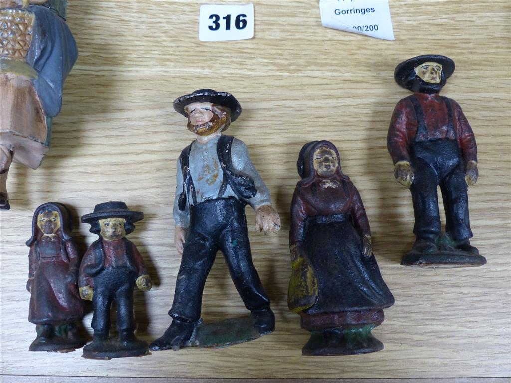 A group of American? painted cast iron and metal Amish figures, sheep money box etc.